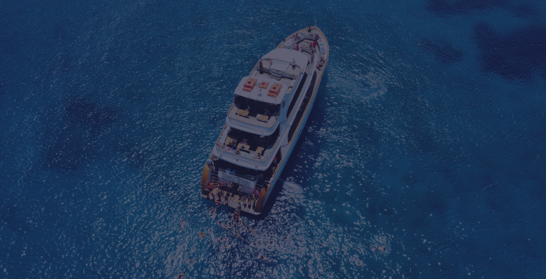 Cape Greco boat tour aerial view of Ocean Queen in crystal blue water